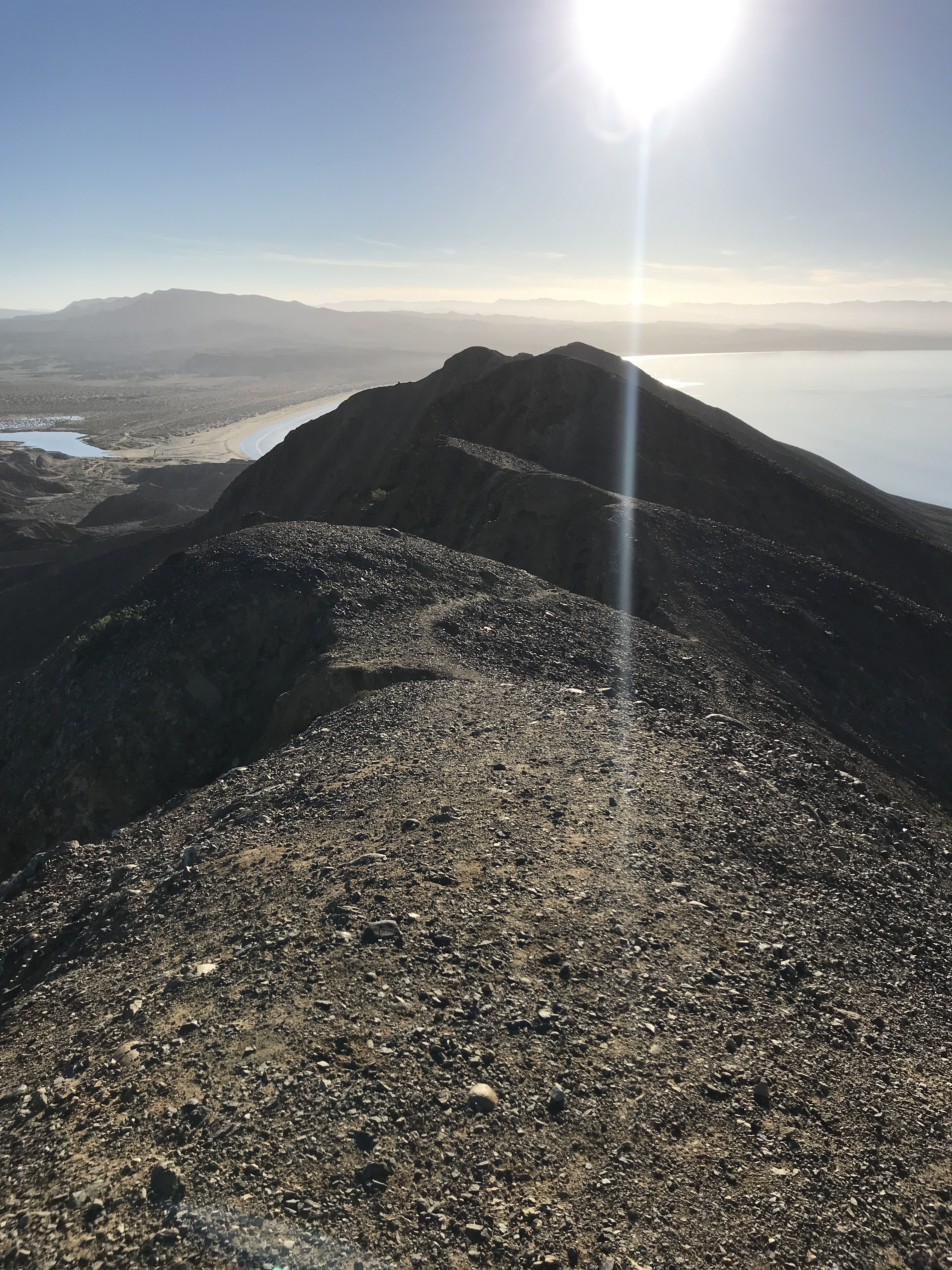 sun above the summit, glimpse of beach and bay